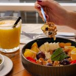 Enjoy a nutritious breakfast with fruit, nuts, and juice in a calm setting in İzmir, Türkiye.